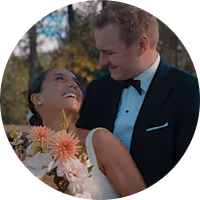 Lucy and Nicholas laughing together at their autumn Montana wedding, dahlias in the bouquet
