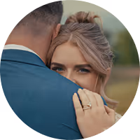 Nicole and Drew in a close embrace at their Montana wedding, a wedding ring catching the light