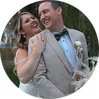 Rylie and Josh laughing, one hugging the other from behind, at their Montana wedding
